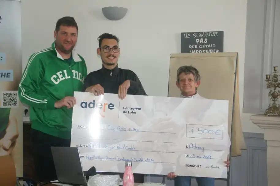 L'équipe d'ADERE prennent la pose avec le chèque de 1 500€ pour l'APHL.